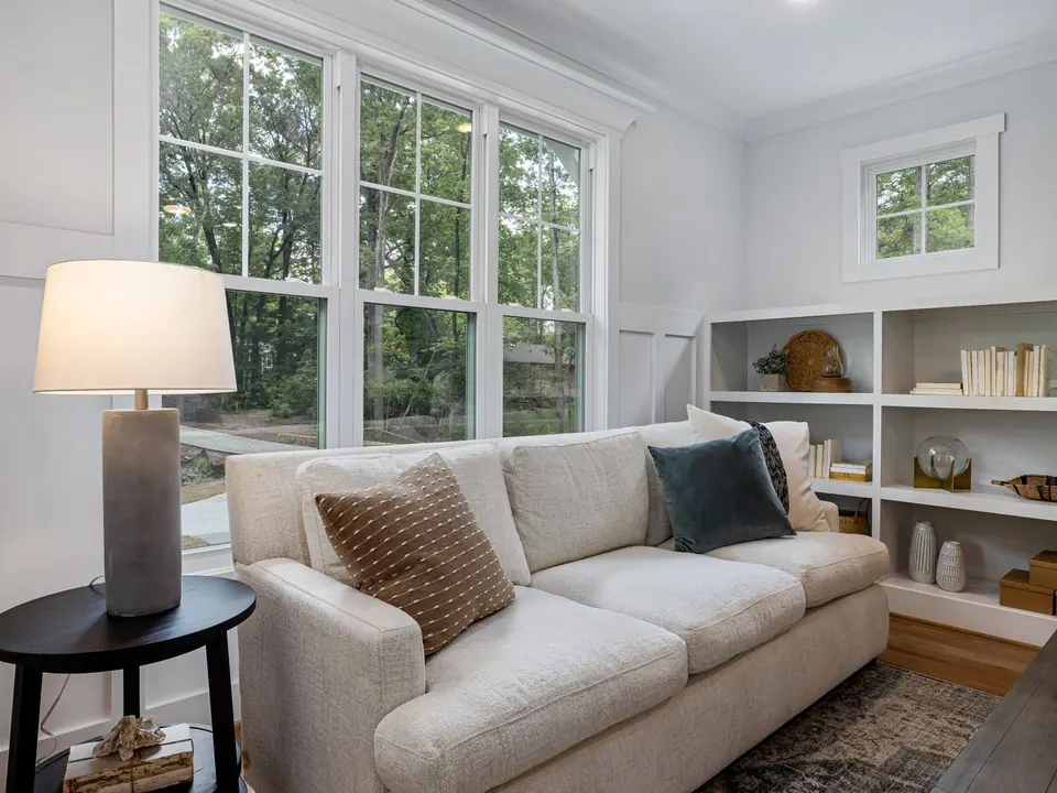 Bright living room with a bank of white double-hung windows